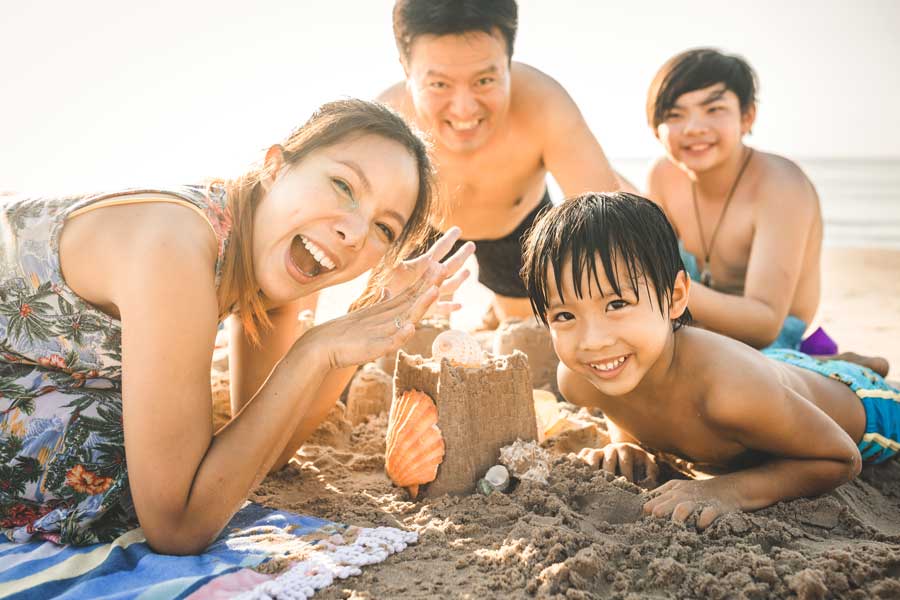 Asian-family-on-beach-having-fun